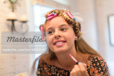 Teenager putting on make-up in bathroom