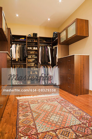 Walk-in closet with carpet in extension in luxurious cottage style log home, Quebec, Canada
