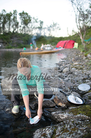 Woman washing dishes outdoor