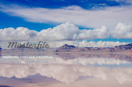 Reflection pool of horizon over water, mountain range and clouds, Bonneville, Utah, USA