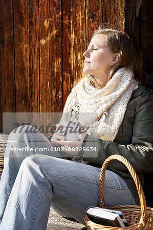 Woman holding mug and relaxing