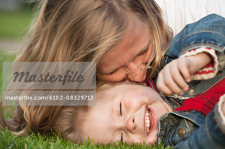 Mother with daughter playing on grass