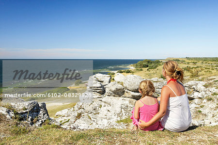 Mother and daughter looking at sea