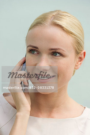 Woman talkiing on cell phone, smiling