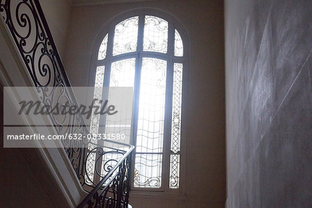 Arched window at top of stairs