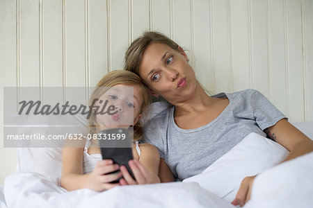 Mother and daughter posing for selfie