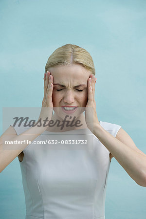 Woman holding head in frustration