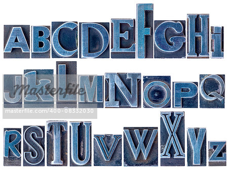 English alphabet - a collage of 26 isolated letters in letterpress metal type printing blocks, a variety of mixed fonts stained by blue ink