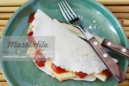 Casabe (bammy, beiju, bob, biju) - flatbread made from cassava (tapioca) with cheese and goiabada jam (Romeo and Juliet dessert). Selective focus