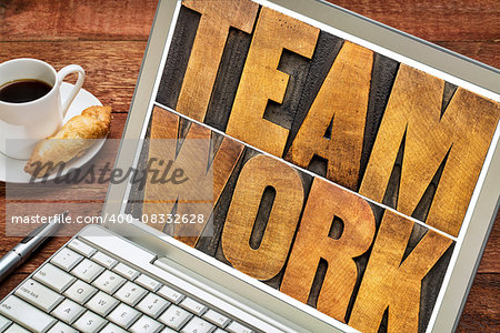 teamwork word typography - letterpress wood type printing blocks on a laptop screen with a cup of coffee
