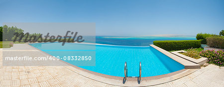 Panoramic view from a luxury infinity swimming pool with tropical sea outlook