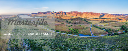 aerial panorama of foothills near Fort Collins, Colorado with Horsetooth Reservoir, Lory State Park, Charles Hansen Canal and Centennial Road, sunrise at late summer