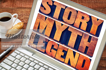 story, myth, legend word abstract - storytelling concept -  collage of words in vintage letterpress wood type printing blocks on a laptop screen with a cup of coffee