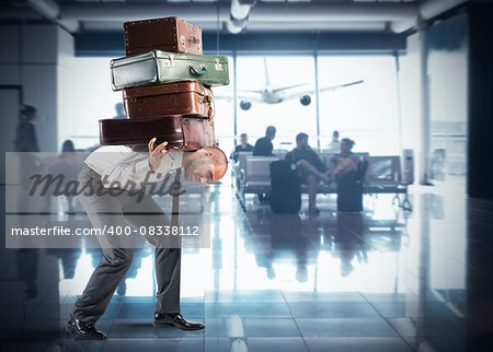 Businessman with so many suitcases inside airport