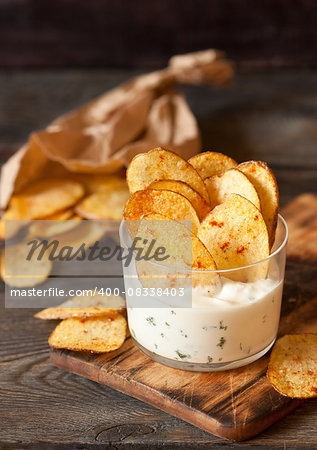 Homemade fries potato ships with dip served in glass.