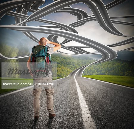 Confused explorer man before a winding road
