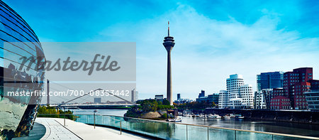 View of the Rheinturm Dusseldorf (TV Tower) in Media Harbour with Neuer Zollhof  on the right, Dusseldorf, Germany