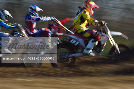 Motocross bikers on dirt track