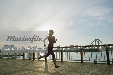 Young Japanese woman running downtown Tokyo