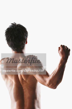 Japanese male athlete showing off muscles