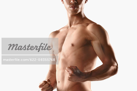 Japanese male athlete showing off muscles