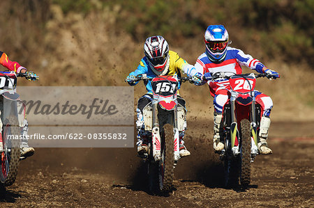 Motocross bikers on dirt track