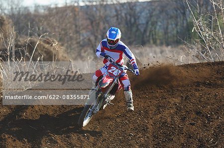 Motocross biker on dirt track