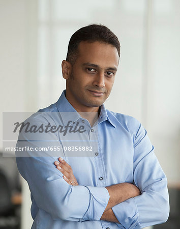 Singapore, Businessman standing with folded arms Singapore, Businessman standing with folded arms