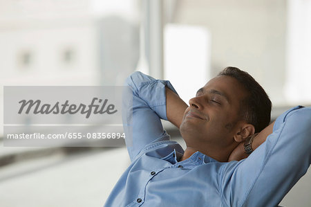 Singapore, Close up of businessman sitting with eyes closed