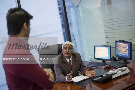 India, Senior businessman interviewing younger man