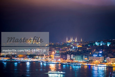 Blue Mosque (Sultan Ahmet Mosque) and Hagia Sophia (Aya Sofya) at night seen from The Galata Tower across the Bosphorus Strait, Istanbul, Turkey, Europe