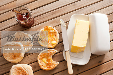 High Angle View of Toasted English Muffins with Butter and Jam on Top of Wooden Table