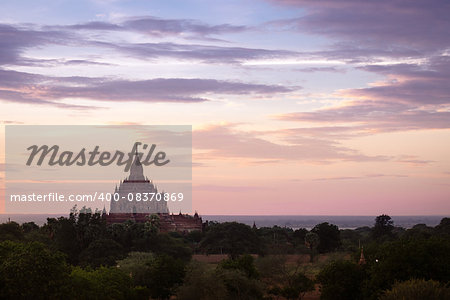Scenic colorful sunset of ancient temple in Bagan with dramatic clouds, Myanmar