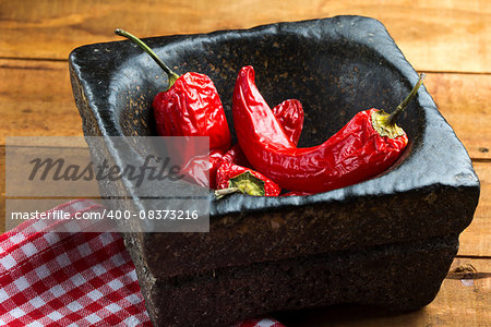 dried red hot chili peper on the wooden table horizontal