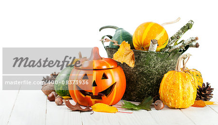 Holiday Halloween autumn decoration with jack-o-lantern pumpkins and yellow leaves