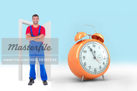 Handyman in overalls standing arms crossed over white backgound against alarm clock counting down to twelve