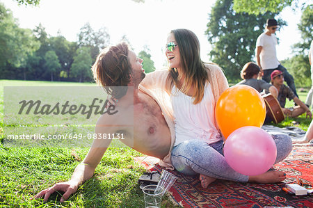 Young couple flirting at park party