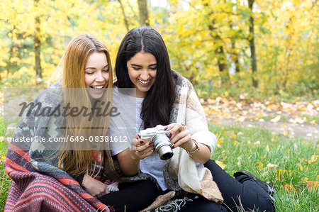 Young women smiling at camera in forest, Hampstead Heath, London