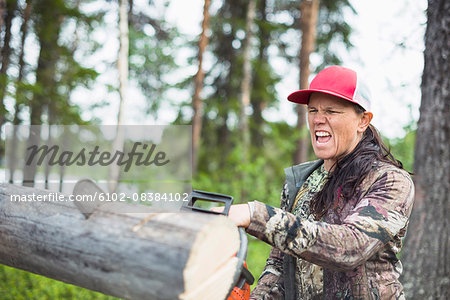 Woman using chainsaw