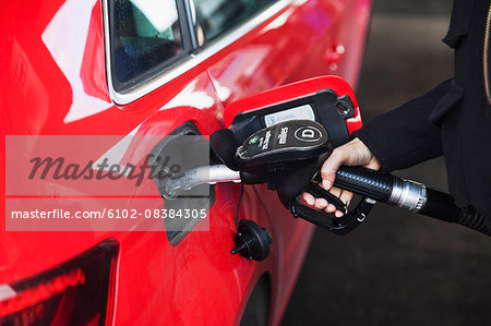 Woman pumping gas