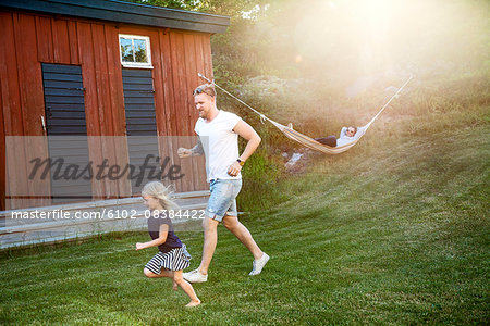 Father with daughter playing in garden