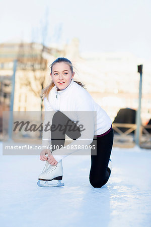 Woman lacing ice skate