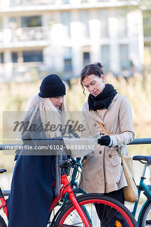 Women with bicycles looking at map
