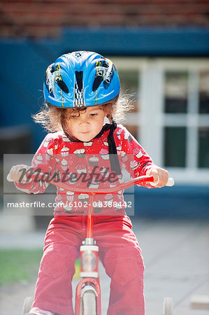 Girl riding small bicycle