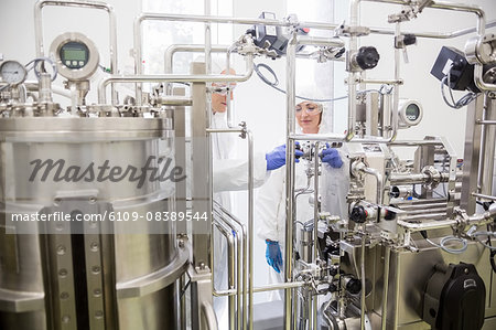 Scientists working with large vat