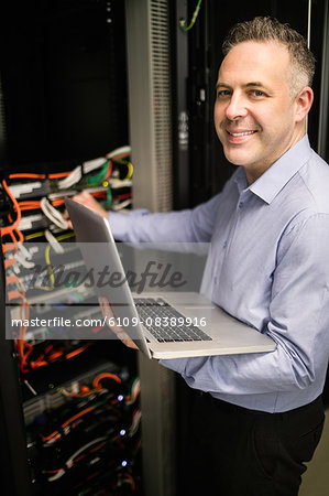 Technician looking at open server locker