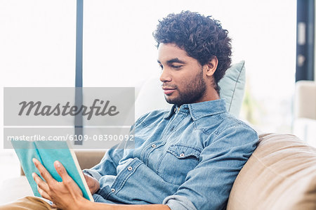 Handsome man reading book