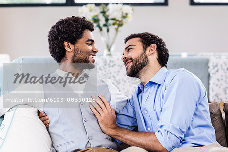 Happy gay couple looking to each other