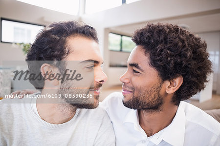 Happy gay couple looking to each other