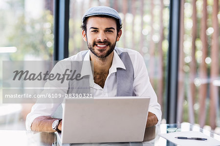 Smiling man using laptop